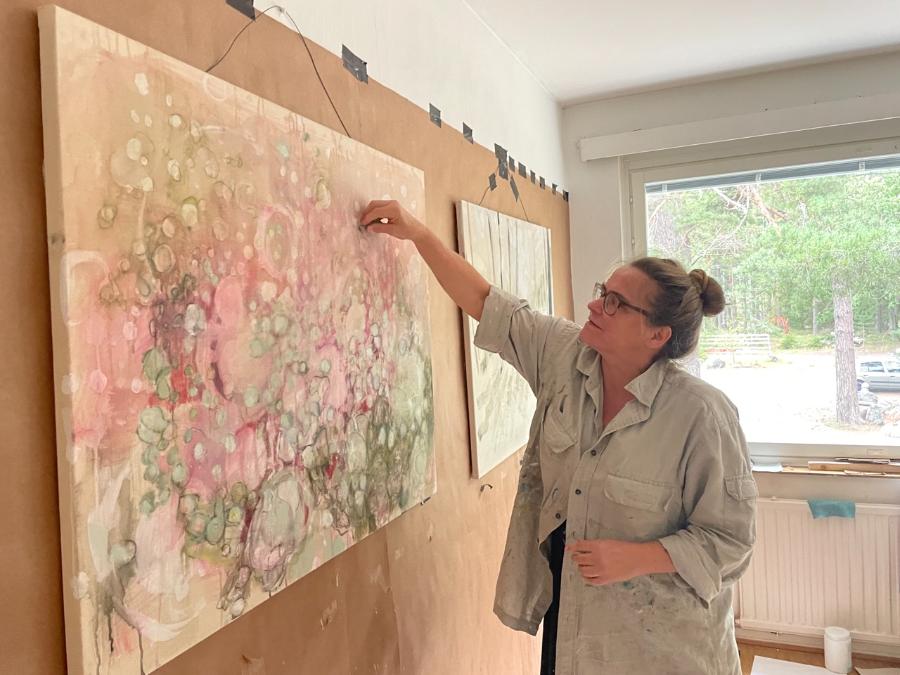 Painter Susann Rittermann in front of her paintings in AARK studio