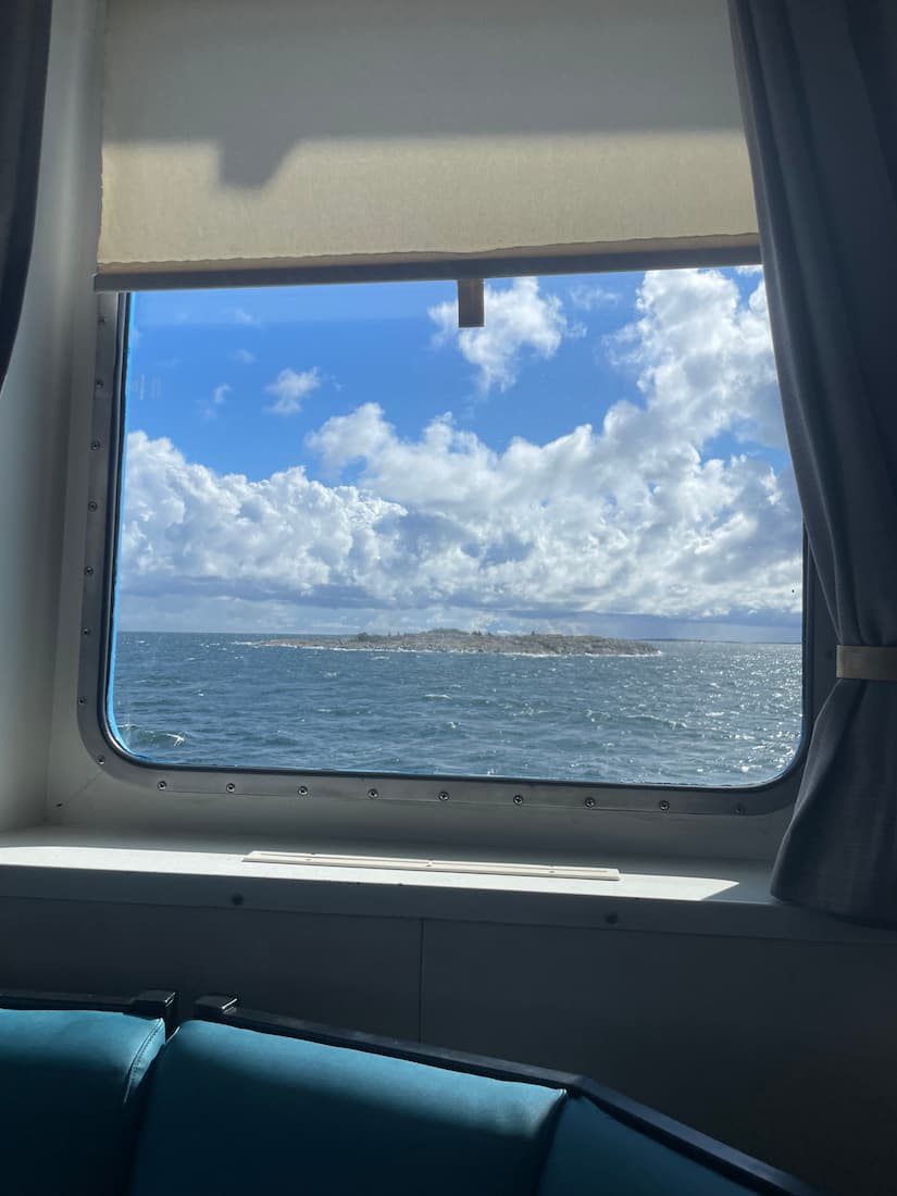 An image of a burning candle in the black sand.